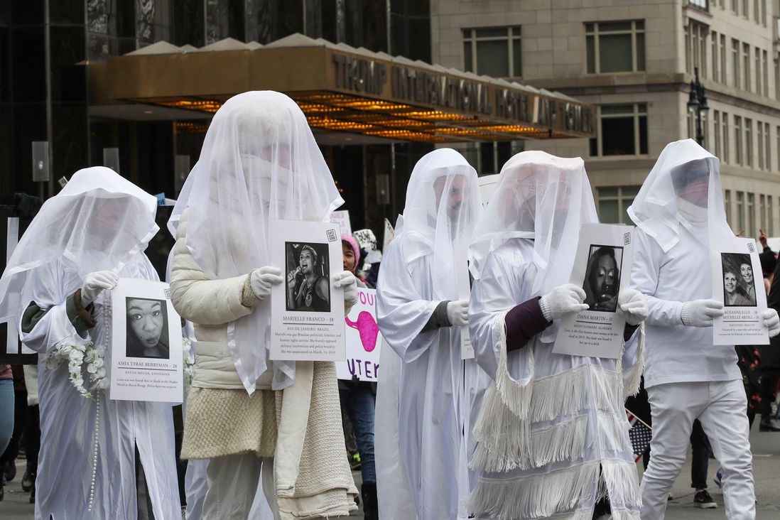 People participating in the NYC Women's March carry images of victims of gun violence (Mary Altaffer/AP/Shutterstock)